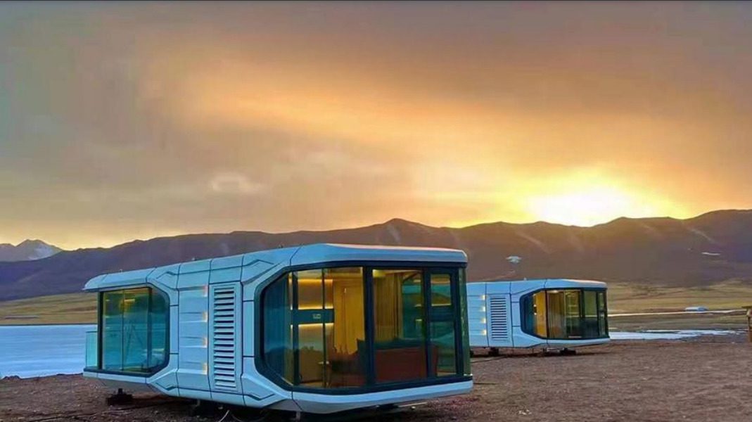 A couple of small houses sitting in the sand.