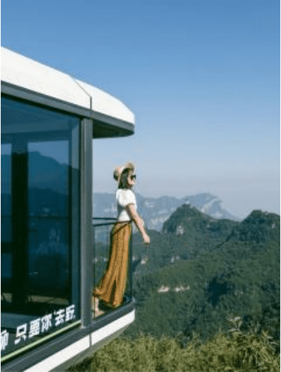 A woman standing on the side of a building.