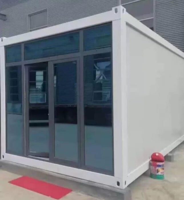 A white container with sliding glass doors on the outside.